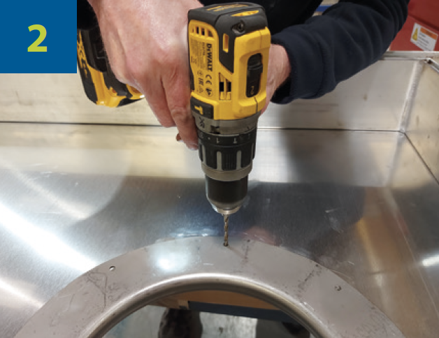 Industrial worker inserting the formed inspection ring into the hole and drill 8 x 5.5mm (7/32”) holes.