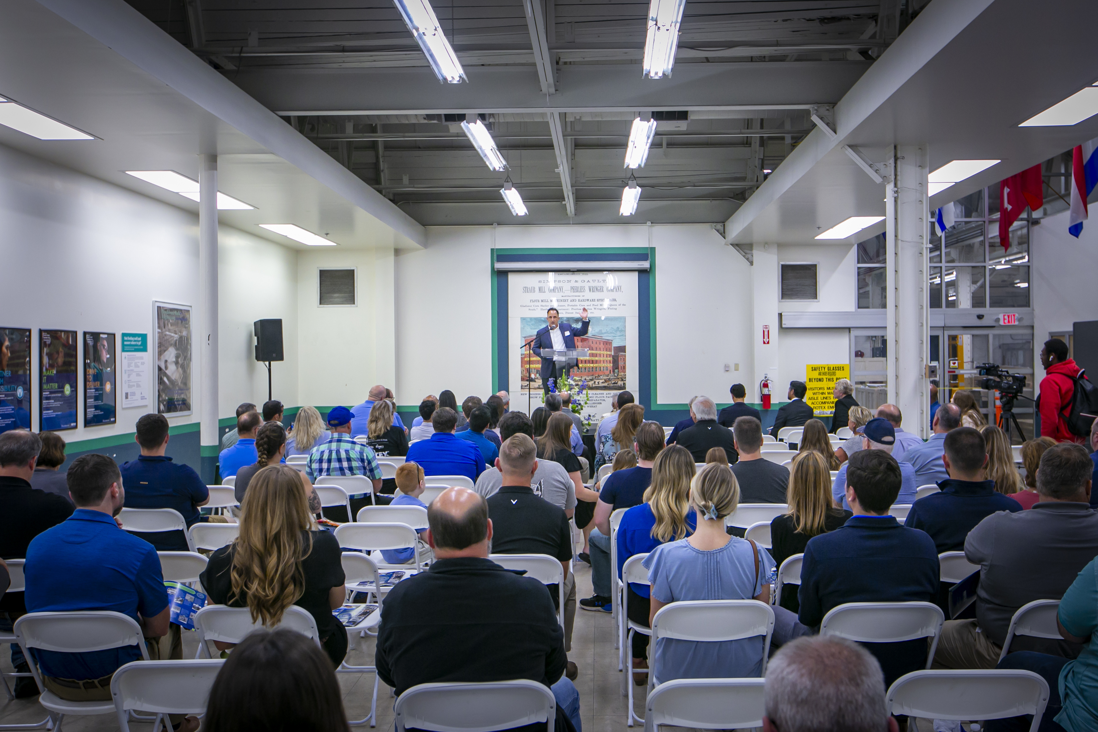 A room full of people listening to a speaker at the Rotex 180th Anniversary Event.